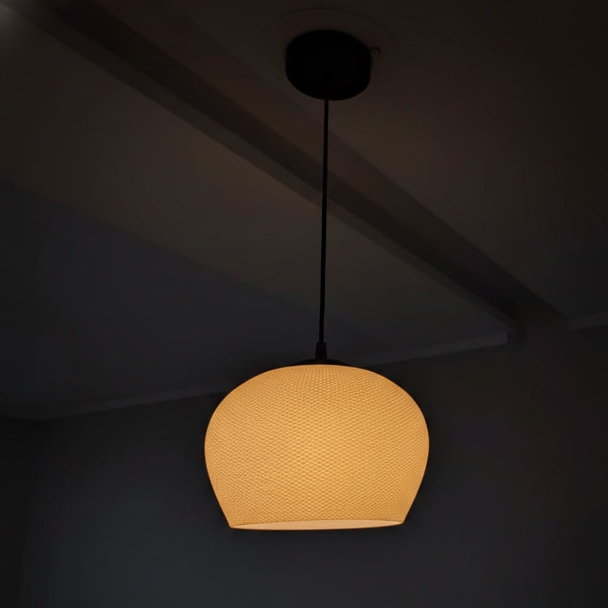 Yellow pendant light hanging against a dark background